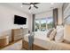 Comfortable main bedroom boasts hardwood floors, patio access with pool view, ceiling fan, and en-suite bath at 2621 Anchor Watch Dr, Wadmalaw Island, SC 29487