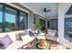 Relaxing covered patio featuring a cozy sofa, chair and view of the manicured backyard at 2621 Anchor Watch Dr, Wadmalaw Island, SC 29487