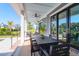 Stylish outdoor seating area with a dining table, sofa and views of the backyard and trees at 2621 Anchor Watch Dr, Wadmalaw Island, SC 29487