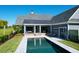 An aerial view of an amazing backyard featuring an in-ground swimming pool and patio with outdoor furniture at 2621 Anchor Watch Dr, Wadmalaw Island, SC 29487