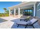 Backyard with a covered patio and sun loungers, next to a sparkling inground pool at 2621 Anchor Watch Dr, Wadmalaw Island, SC 29487