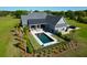Stunning backyard featuring a pool, patio, and well-manicured lawn with mature trees at 2621 Anchor Watch Dr, Wadmalaw Island, SC 29487