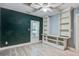 This bedroom features an integrated shelving unit, a window, ceiling fan and LVP flooring at 2702 Decatur St, North Charleston, SC 29405