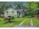 Charming home with inviting front yard, lush greenery, and private driveway at 2702 Decatur St, North Charleston, SC 29405