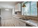 Bright kitchen featuring white cabinets, stainless appliances, granite countertops, stainless sink and light fixture at 2702 Decatur St, North Charleston, SC 29405
