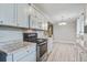 Bright kitchen featuring stainless steel appliances, granite countertops, and white cabinetry at 2702 Decatur St, North Charleston, SC 29405