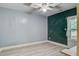 Empty room with light grey walls, dark green wall, ceiling fan and light wood flooring at 2702 Decatur St, North Charleston, SC 29405