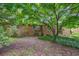 The brick home features a backyard with mature shade trees and native vegetation at 2903 Shadow Ln, North Charleston, SC 29406