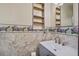 Small, charming bathroom with patterned wallpaper, updated vanity and brushed nickel faucet at 2903 Shadow Ln, North Charleston, SC 29406