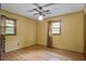 Bright, neutral bedroom features hardwood floors, two windows, and a ceiling fan at 2903 Shadow Ln, North Charleston, SC 29406