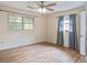 Bright bedroom features hardwood floors, two windows, and neutral paint at 2903 Shadow Ln, North Charleston, SC 29406