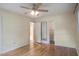 Bedroom features hardwood floors, ceiling fan, and access to the bathroom and closet at 2903 Shadow Ln, North Charleston, SC 29406