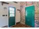 Mud room entry with green doors, brick wall, wood floors and key rack at 2903 Shadow Ln, North Charleston, SC 29406