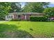 Charming single-story brick home with a well-maintained lawn and mature trees at 2903 Shadow Ln, North Charleston, SC 29406