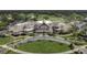 Aerial view of the clubhouse featuring a grand entrance, mature landscaping, and large parking area at 2942 Atrium Villa Dr # 42, Johns Island, SC 29455