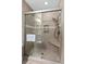 Neutral bathroom featuring a glass enclosed shower with tiled walls, integrated shelving and bench, offering spa-like comfort at 2942 Atrium Villa Dr # 42, Johns Island, SC 29455