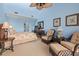 Comfortable bedroom showcasing blue walls, vaulted ceiling, ceiling fan and woven furniture creating a cozy and inviting atmosphere at 2942 Atrium Villa Dr # 42, Johns Island, SC 29455