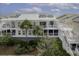 Inviting multi-story condo with private balconies, palm trees, and lush landscaping at 2942 Atrium Villa Dr # 42, Johns Island, SC 29455