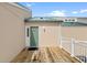 Inviting front door with a modern design and a spacious wooden deck, enhancing curb appeal at 2942 Atrium Villa Dr # 42, Johns Island, SC 29455