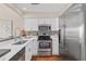 Modern kitchen features stainless steel appliances, a tiled backsplash, and bright white cabinets at 2942 Atrium Villa Dr # 42, Johns Island, SC 29455