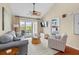 Bright living room with vaulted ceiling, ceiling fan, and sliding glass doors to the outdoor patio at 2942 Atrium Villa Dr # 42, Johns Island, SC 29455