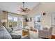 Bright living room with vaulted ceiling, ceiling fan, and sliding glass doors to the outdoor patio at 2942 Atrium Villa Dr # 42, Johns Island, SC 29455