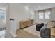 Sitting area with plush sofa, woven stools, and a view of the staircase at 3035 Robeson Trce, Johns Island, SC 29455