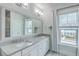 Bright bathroom featuring double sinks, a large mirror, and natural light from the window at 3125 Sturbridge Rd, Mount Pleasant, SC 29466
