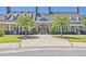 Elegant clubhouse with a brick entryway, manicured lawn, mature trees, and ample parking for gatherings at 3125 Sturbridge Rd, Mount Pleasant, SC 29466