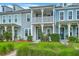 Charming townhomes featuring colorful exteriors, a second story porch, and well-maintained landscaping at 3125 Sturbridge Rd, Mount Pleasant, SC 29466