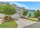 Light blue townhome featuring a two-car garage, tidy landscaping, and well-kept front lawn at 3125 Sturbridge Rd, Mount Pleasant, SC 29466