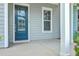 A charming front porch and entry featuring a stylish blue door and ample natural light at 3125 Sturbridge Rd, Mount Pleasant, SC 29466