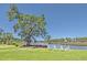 Scenic water view featuring a lush lawn, mature trees, and comfortable chairs for relaxation by the waterway at 3125 Sturbridge Rd, Mount Pleasant, SC 29466