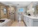 Bathroom featuring a corner shower, soaking tub, and double sink vanity at 316 Anadale Ct, North Charleston, SC 29418