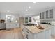 Bright kitchen featuring an island with seating, gas cooktop, and white cabinetry at 316 Anadale Ct, North Charleston, SC 29418