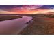 Scenic waterfront landscape, featuring vibrant sunset colors reflecting on the tranquil waterway at 316 Anadale Ct, North Charleston, SC 29418
