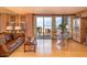Bright living room with hardwood floors, a leather sofa, and a balcony with a view at 330 Concord St # 8E, Charleston, SC 29401
