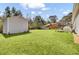 Lush backyard with a storage shed, mature trees, a playground, and a swing, perfect for outdoor activities and enjoyment at 3473 Plow Ground Rd, Johns Island, SC 29455