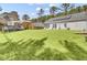 Expansive backyard featuring a pool with deck, a solar panel roof, lush green lawn, and patio furniture at 3473 Plow Ground Rd, Johns Island, SC 29455