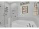 Modern bathroom featuring a glass-enclosed shower and a luxurious soaking tub for relaxation at 3473 Plow Ground Rd, Johns Island, SC 29455