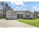 Well-manicured lawn leads to a single-story home with an attached two car garage at 3473 Plow Ground Rd, Johns Island, SC 29455