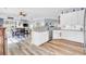 Open kitchen with stainless appliances and granite island, view to dining and living rooms at 3473 Plow Ground Rd, Johns Island, SC 29455