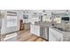 Open-concept kitchen with an island and stainless steel dishwasher, flowing into the dining space at 3473 Plow Ground Rd, Johns Island, SC 29455