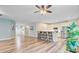 Spacious open-concept living room and kitchen boasts stainless appliances, breakfast bar, and wood floors at 3473 Plow Ground Rd, Johns Island, SC 29455