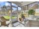 Relaxing screened-in porch with wicker furniture and a view of the beautifully maintained backyard and play structure at 3473 Plow Ground Rd, Johns Island, SC 29455