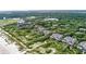 Aerial view of luxury homes nestled in a lush, green landscape near the beach. Address is marked at 3560 Shipwatch Rd, Kiawah Island, SC 29455
