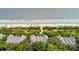 Aerial view of a beachfront home with direct access to the beach, surrounded by greenery and trees at 3560 Shipwatch Rd, Kiawah Island, SC 29455
