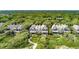 Stunning aerial view of well-maintained homes surrounded by dense forest. Address is marked at 3560 Shipwatch Rd, Kiawah Island, SC 29455