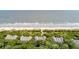 Beautiful aerial view features townhouses near a beach and a sparkling ocean at 3560 Shipwatch Rd, Kiawah Island, SC 29455