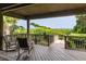 Charming covered balcony with rocking chairs offers a tranquil view of the lush surroundings and ocean at 3560 Shipwatch Rd, Kiawah Island, SC 29455